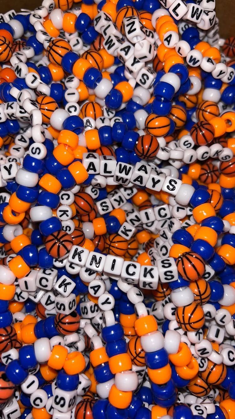 11 Beaded Jewelry DIY Bracelets Ideas for Every Style 7 Beaded bracelets with orange, blue, and white beads and basketball charms.