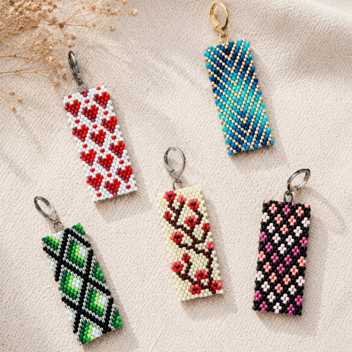 Beaded rectangular charms with various patterns including red hearts and floral designs.