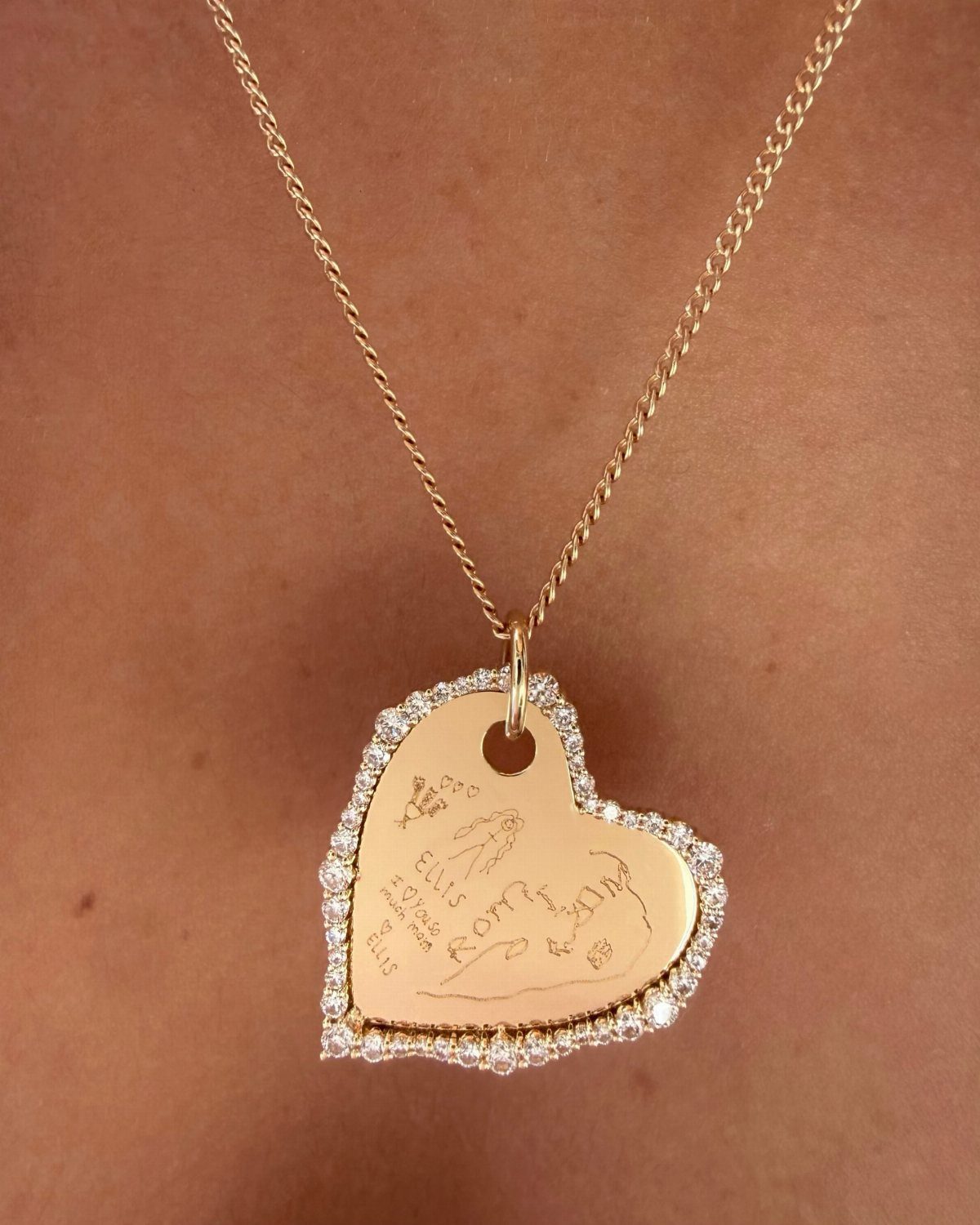Beaded Jewelry Trends 2026: 8 Styles From Chunky Necklaces to Charm Accents 6 Gold heart pendant necklace with engravings and crystal border worn on skin