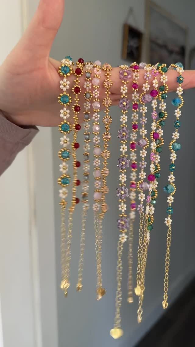 5 Beaded Jewelry with Wire Ideas: Bracelets, Links and Necklaces 5 Colorful beaded necklaces with flower patterns held in a person's hand.