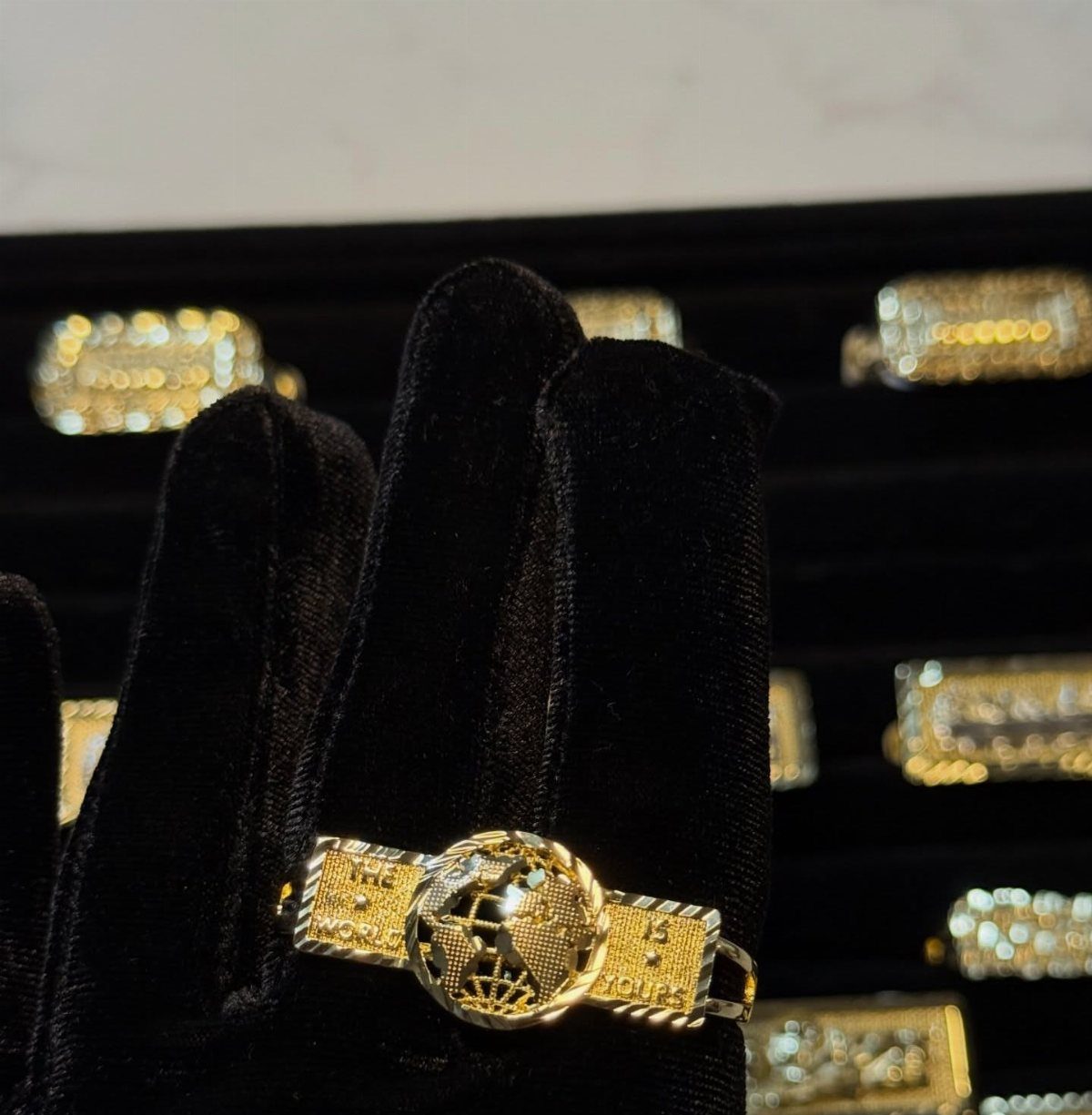 6 Cali Gold Rings for Hearts, Chunky Bands and Twisted Styles 6 Gold ring with a globe center and rectangular bands on black velvet