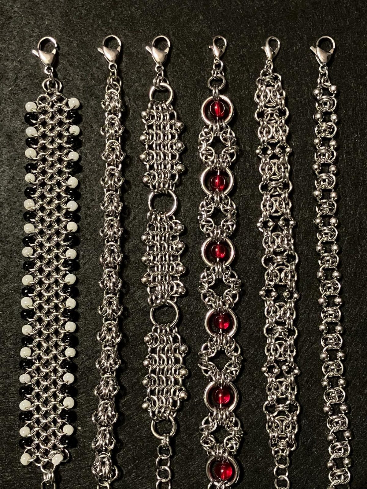 DIY Bracelet Designs: 8 Woven, Beaded and Leather Projects 7 Six silver chain bracelets with various bead accents on a black background