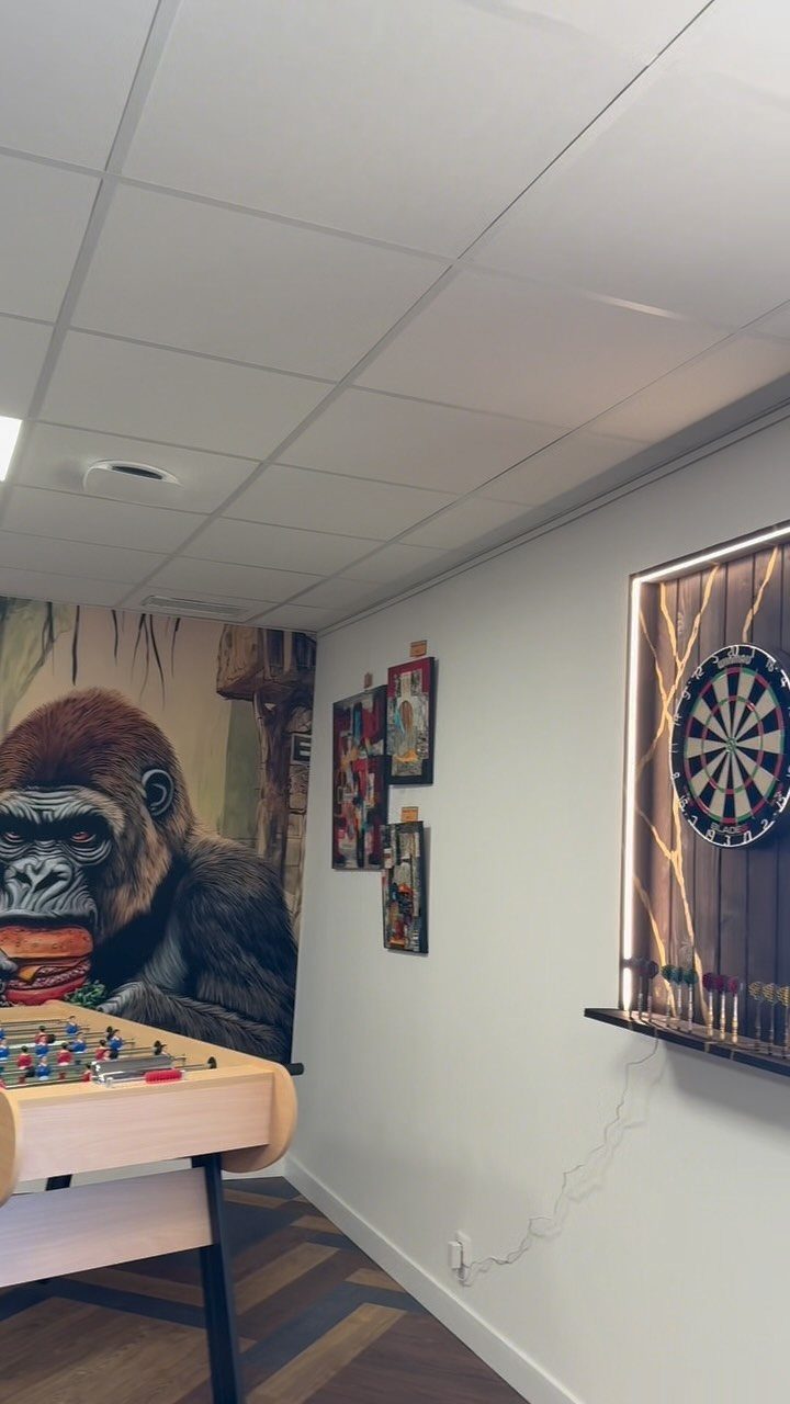 DIY Dart Board Backboard: 7 Clever Projects for Any Style 6 Dartboard mounted on a backlit wooden backboard in a modern game room setting