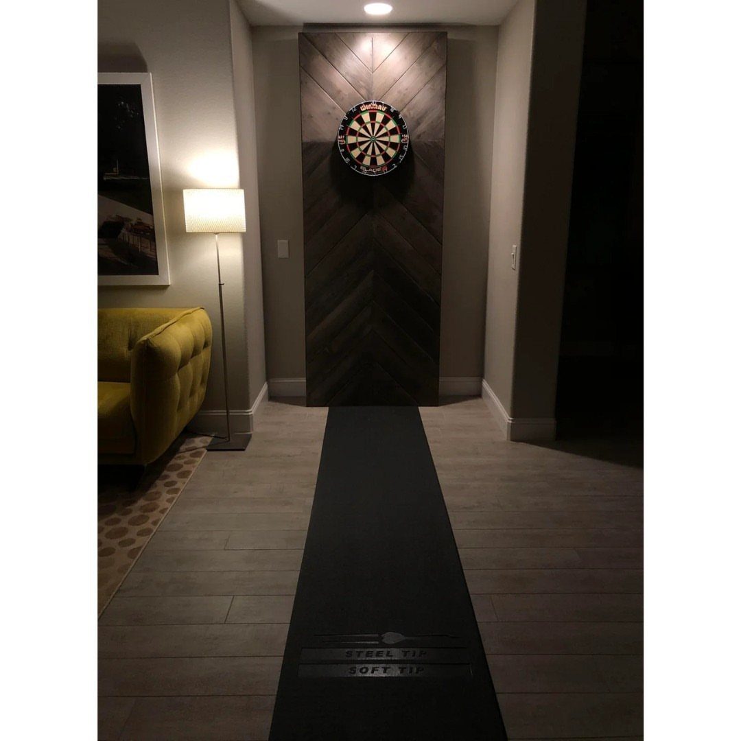 DIY Dart Board Backboard: 7 Clever Projects for Any Style 1 Dartboard mounted on a dark brown chevron wooden backboard in a modern room.