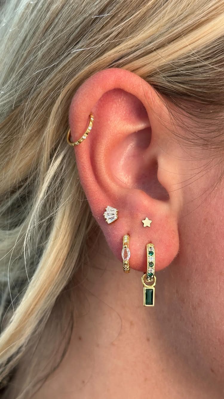 11 Ear Piercing Stack Inspo Ideas to Upgrade Your Look 8 Ear with multiple gold and diamond piercings including a high lobe star stud.