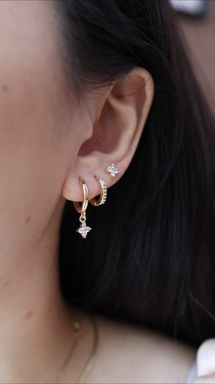 11 Ear Piercing Stack Inspo Ideas to Upgrade Your Look 3 Ear with three gold earrings including a star stud and two gold hoops.