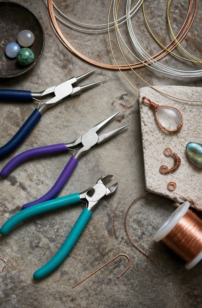 How to Wire Wrap Jewelry: 6 Steps from Wires to Finished Piece 8 Round nose pliers, chain nose pliers, and wire cutters on a surface.