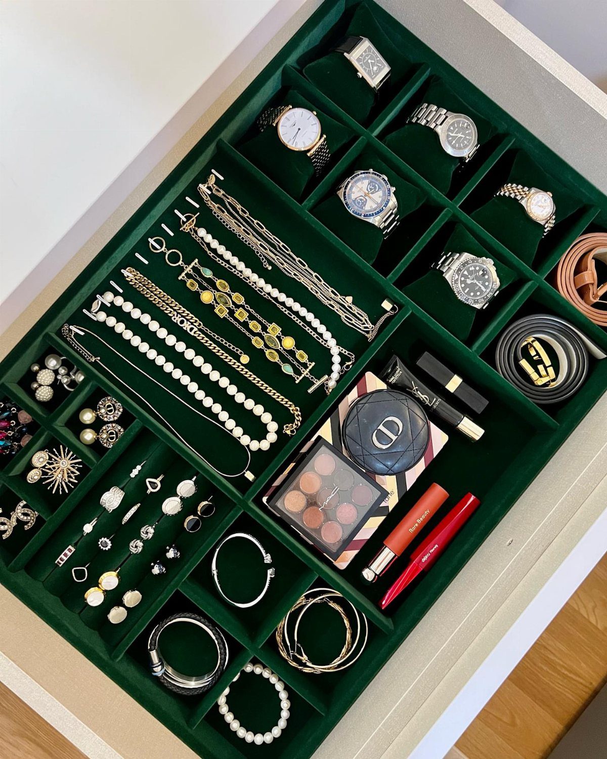12 Ideas for Organizing Jewelry: Wall, Drawer & Travel Storage 7 Green velvet jewelry tray filled with watches, necklaces, rings, and makeup in a drawer