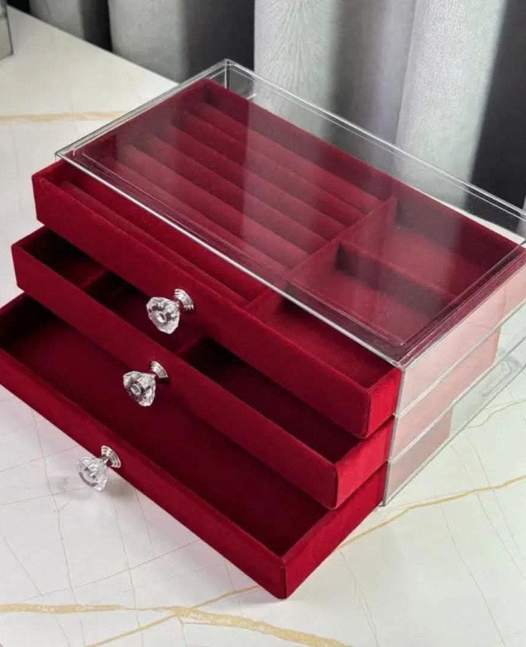 12 Ideas for Organizing Jewelry: Wall, Drawer & Travel Storage 4 Three-tier stackable jewelry organizer with clear acrylic sides and red velvet interior drawers.
