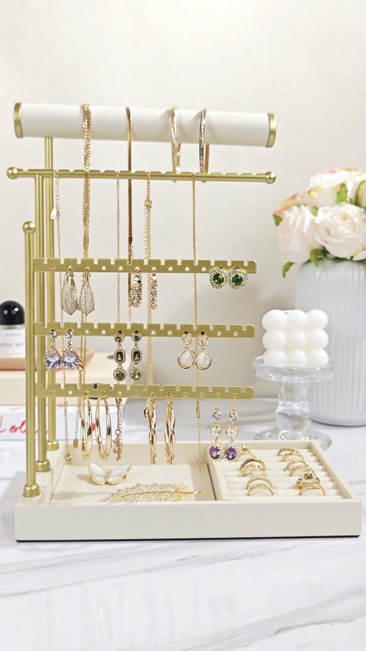 10 Jewellery Holder Ideas for Every Dressing Table 3 Gold metal jewelry stand holding necklaces and earrings on a white marble surface