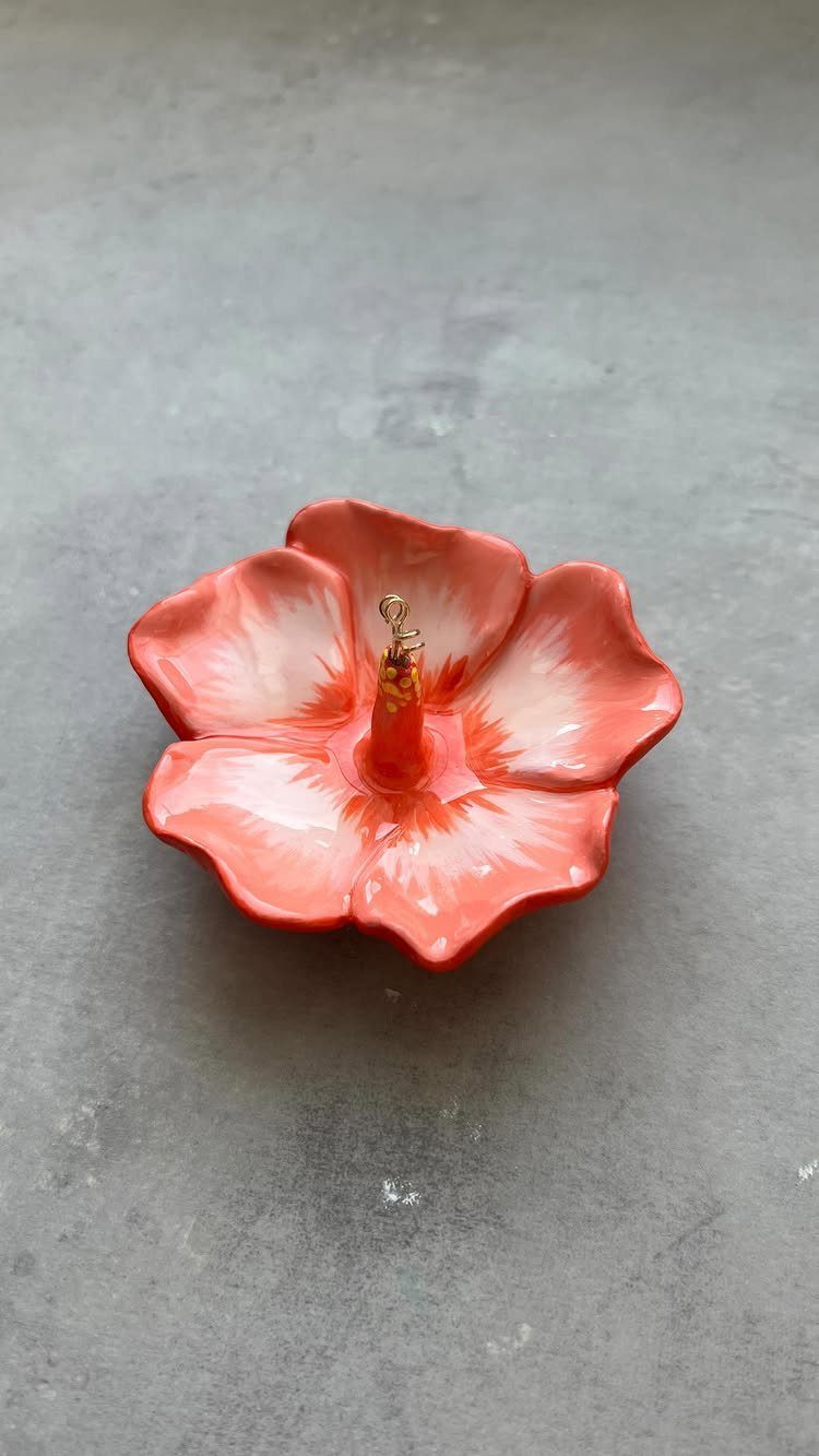 10 Jewellery Holder Ideas for Every Dressing Table 10 Coral flower shaped ceramic ring dish with a gold ring on a grey surface