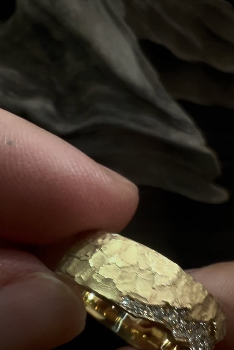 19 Jewelry Aesthetic Gold Ideas for Easy Style 9 Hammered gold ring with diamond accents held between two fingers