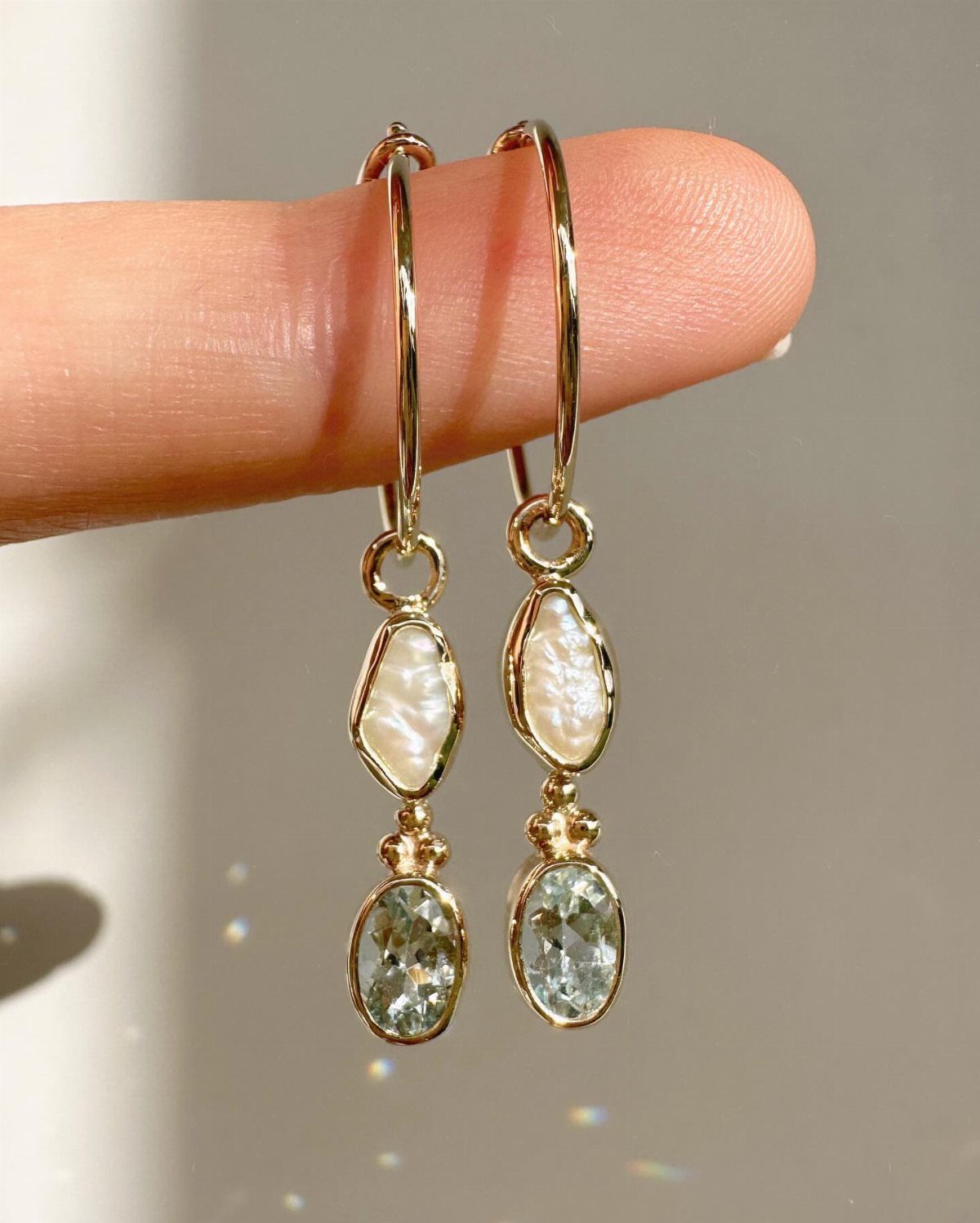 19 Jewelry Aesthetic Gold Ideas for Easy Style 11 Gold hoop earrings with organic white pearls and light blue oval gemstones.