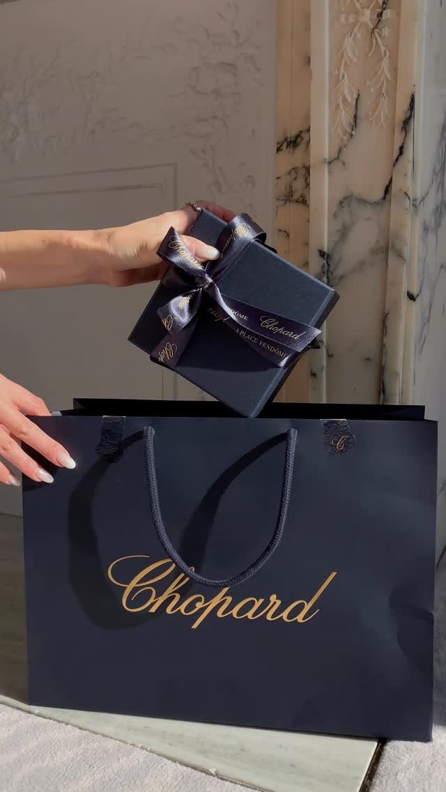 9 Jewelry Brand Logos From Tiffany Blue to Swarovski Swan 2 Chopard shopping bag and gift box with gold cursive logo on dark blue background