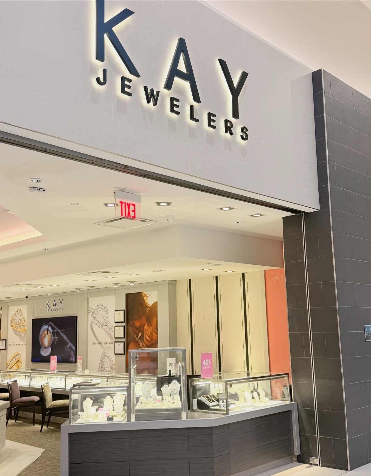 9 Jewelry Brand Logos From Tiffany Blue to Swarovski Swan 4 Kay Jewelers storefront sign above a brightly lit jewelry store interior with displays.
