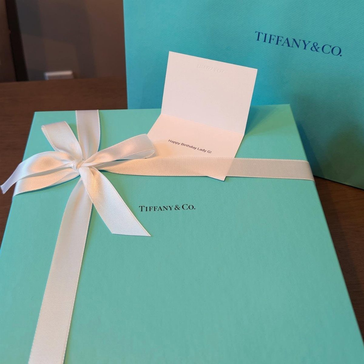 9 Jewelry Brand Logos From Tiffany Blue to Swarovski Swan 1 Turquoise Tiffany and Co gift boxes with a white satin ribbon bow.