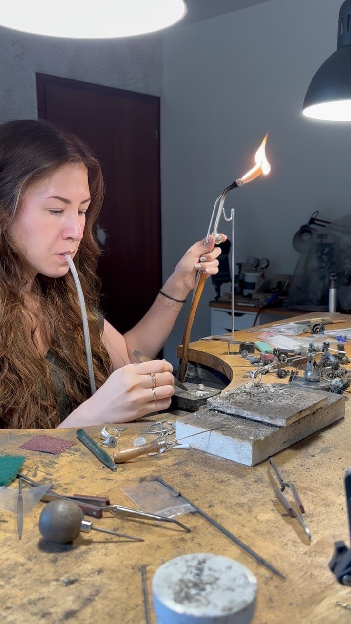 19 Jewelry Posting Ideas for Instagram That Build Sales 1 Jeweler using a blowtorch to solder metal pieces at a professional workbench.