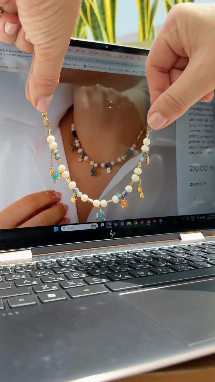 19 Jewelry Posting Ideas for Instagram That Build Sales 13 Beaded necklace held in front of a laptop screen showing a jewelry website