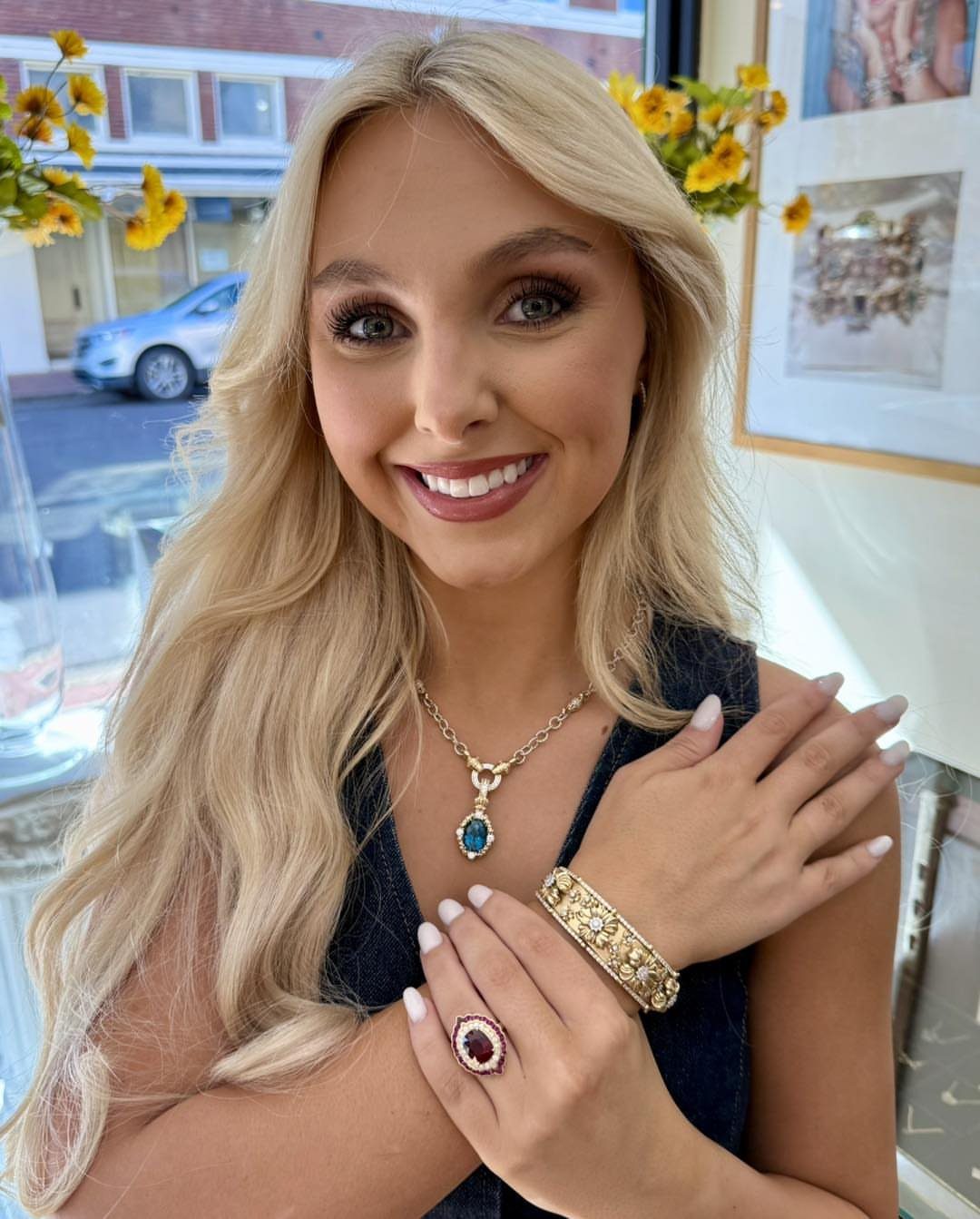 19 Jewelry Posting Ideas for Instagram That Build Sales 3 Blonde woman smiling while wearing a gold gemstone necklace, bracelet, and ring.