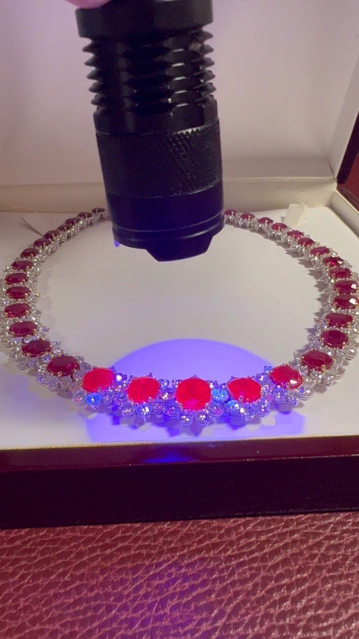 19 Jewelry Posting Ideas for Instagram That Build Sales 19 Silver necklace with red gemstones illuminated by a flashlight in a white box