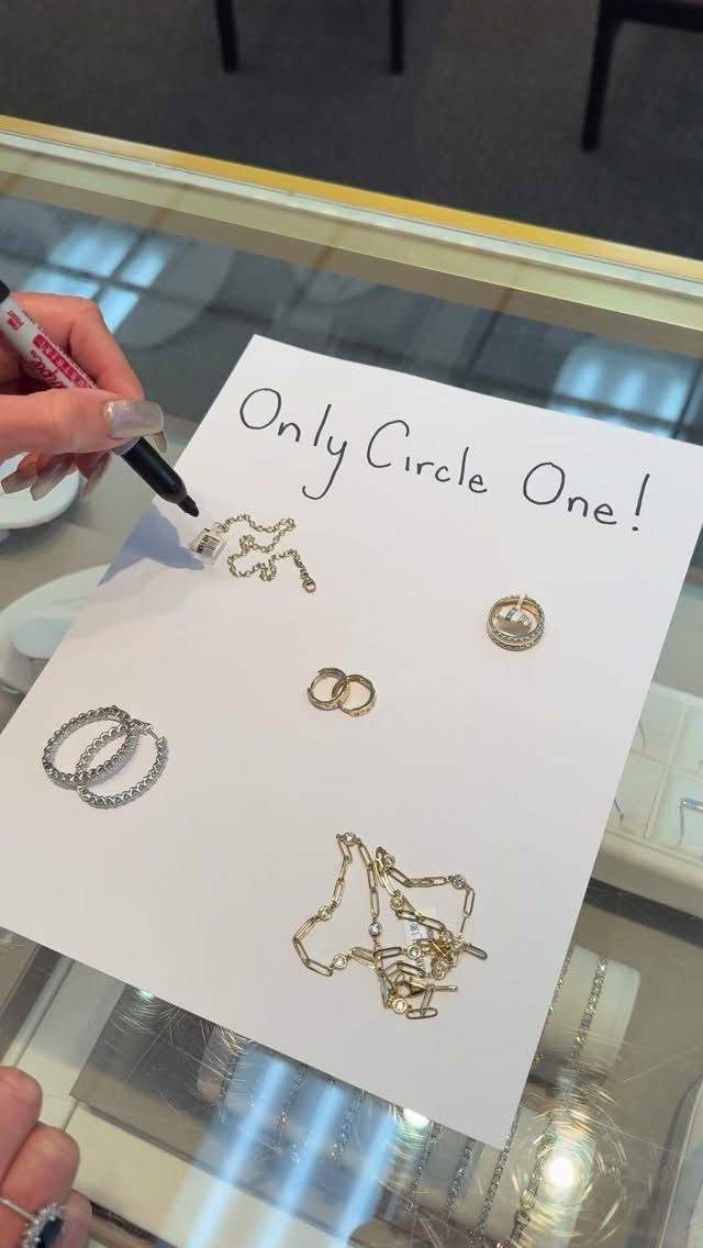 19 Jewelry Posting Ideas for Instagram That Build Sales 5 Hand circling a gold necklace on paper with other jewelry and handwritten text.