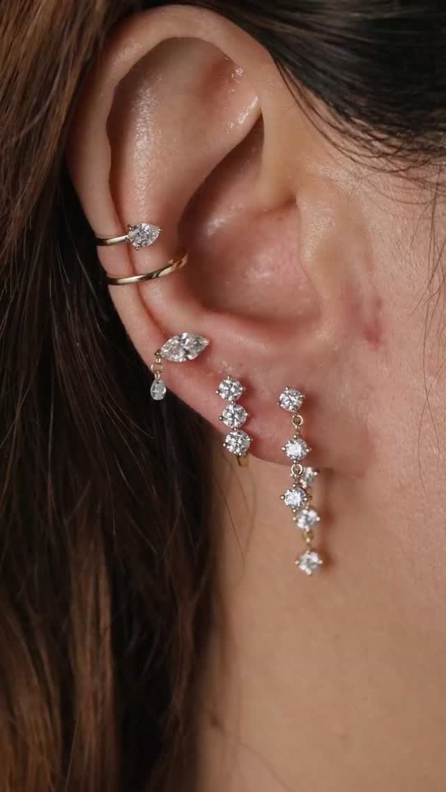 12 Jewelry Stack Inspo Earrings Ideas 5 Ear with a cascading stack of gold and diamond earrings of varying lengths.