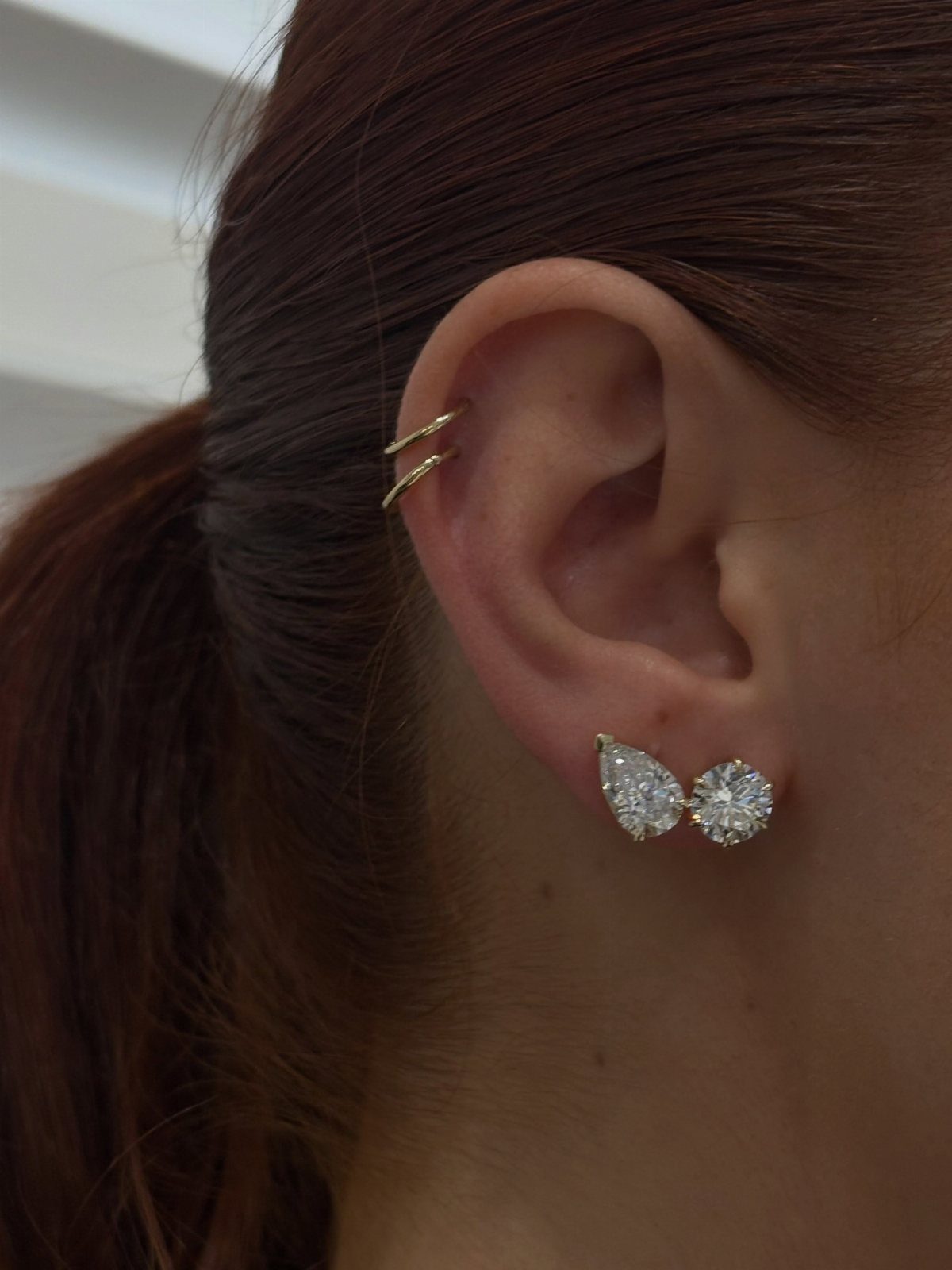 12 Jewelry Stack Inspo Earrings Ideas 3 Earring stack with gold ear cuffs and diamond studs on a person's ear