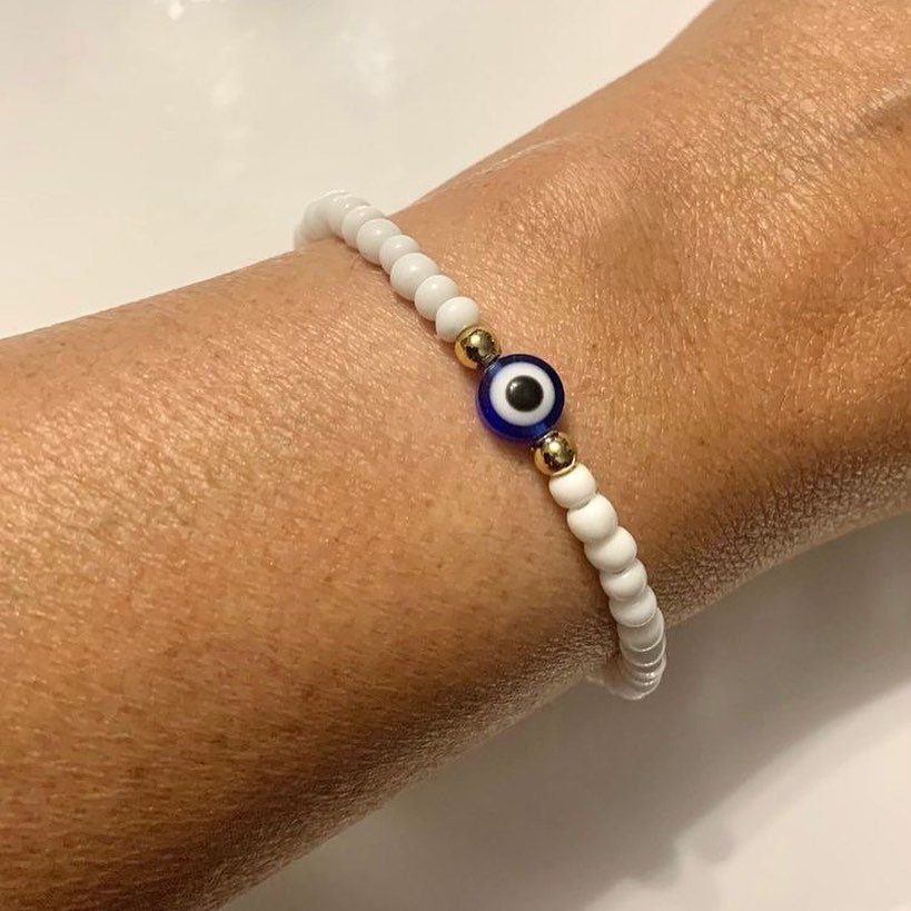 Seed Bead Crafts: 19 Patterns and Projects for 2026 18 White seed bead bracelet with an evil eye charm on a wrist
