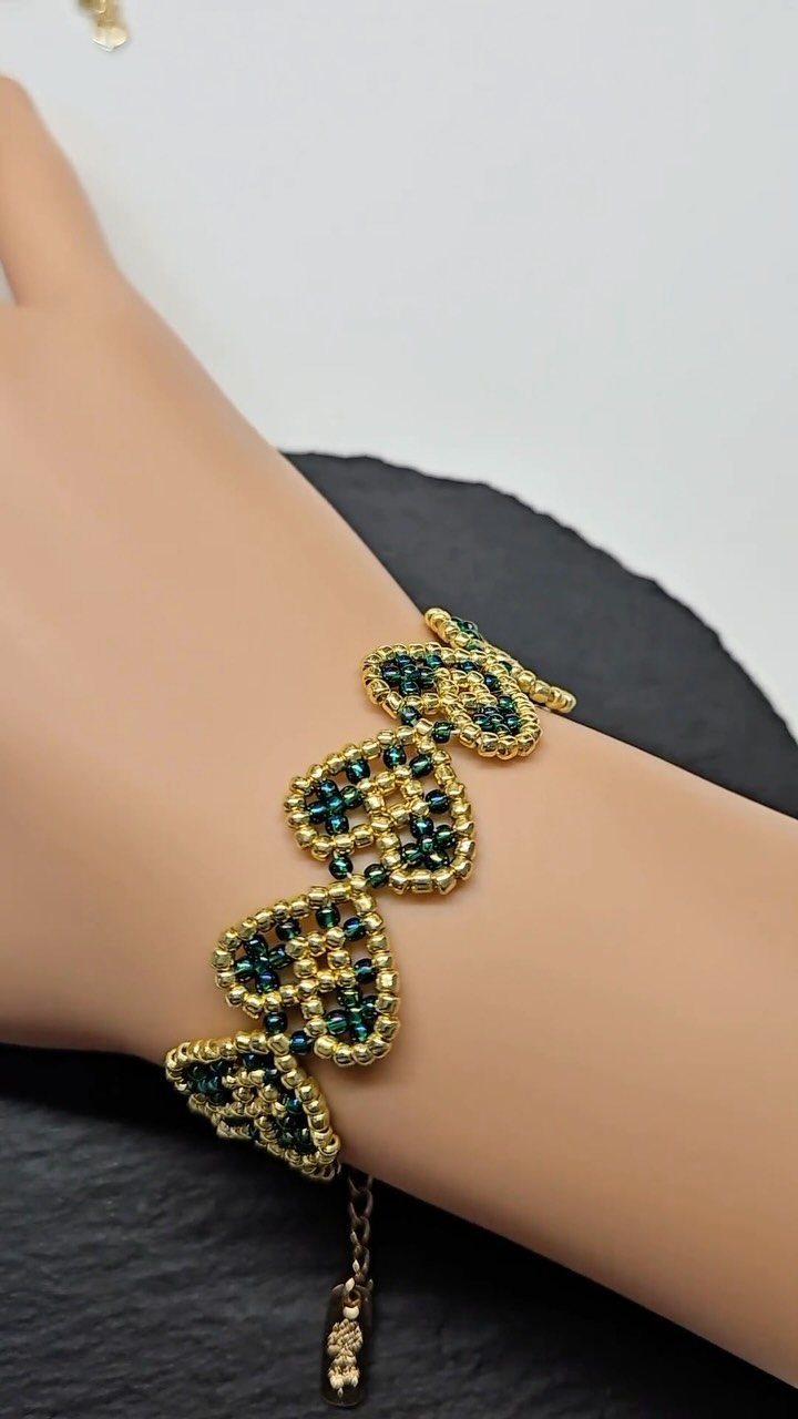 Seed Bead Crafts: 19 Patterns and Projects for 2026 5 Gold and green seed bead bracelet with fish shapes worn on a wrist
