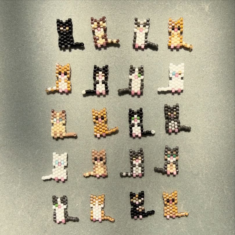 Seed Bead Crafts: 19 Patterns and Projects for 2026 7 Small seed bead cats in various colors arranged in a grid on grey.