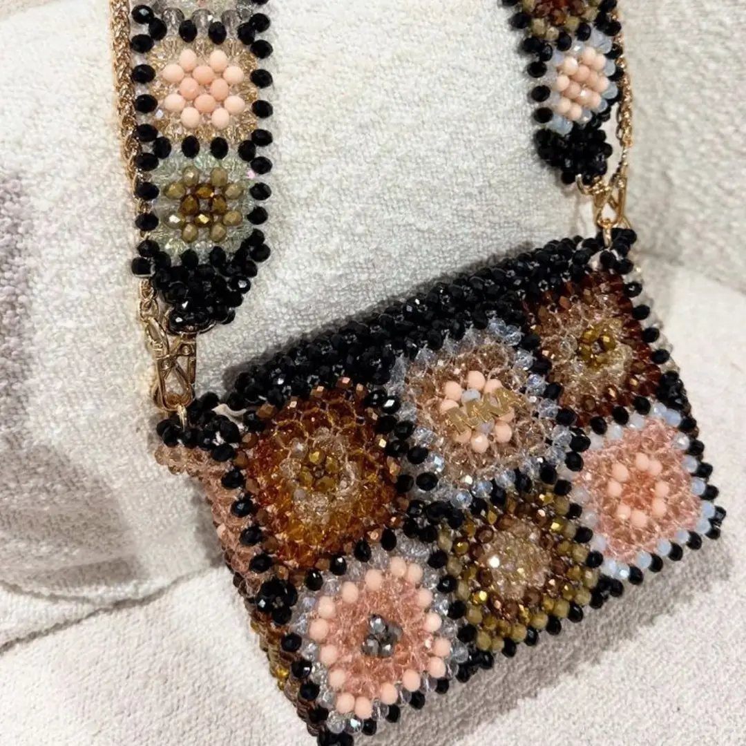 Seed Bead Crafts: 19 Patterns and Projects for 2026 6 Beaded handbag and strap with floral patterns in peach, gold, and black beads.