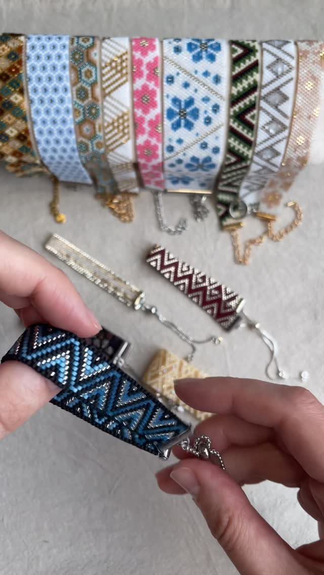 Seed Bead Crafts: 19 Patterns and Projects for 2026 3 Blue and black zigzag seed bead bracelet held by hands among other bracelets.