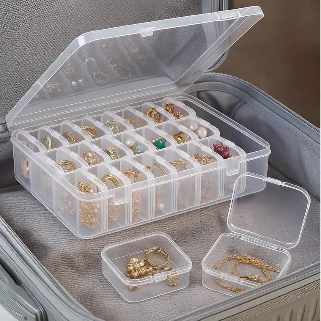 13 Stud Earring Storage Ideas for Every Jewelry Collection 6 Clear plastic compartmentalized jewelry box with gold rings inside a grey suitcase