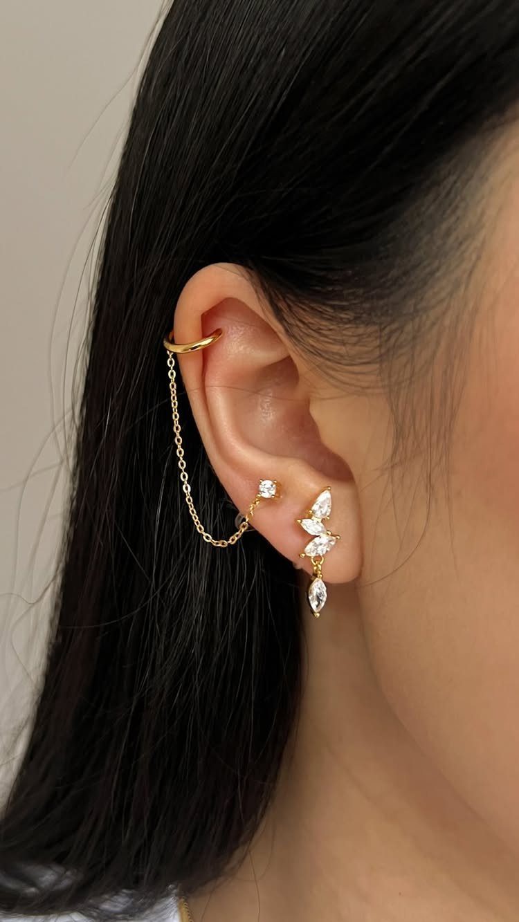 Top of the Ear Piercing Jewelry: 11 Ideas 8 Gold ear jewelry featuring a helix hoop connected by a chain to a lobe stud.