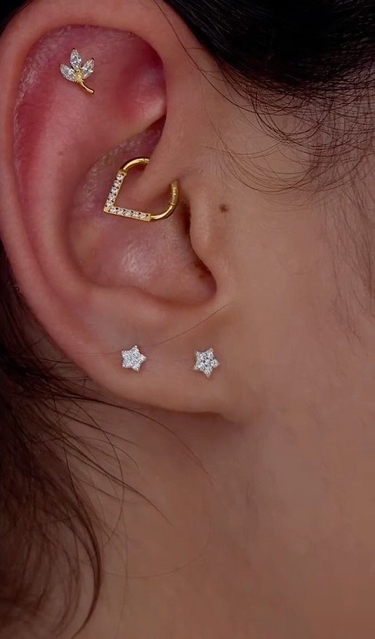 Top of the Ear Piercing Jewelry: 11 Ideas 3 Ear with a gold sparkling hoop daith piercing and star lobe studs.