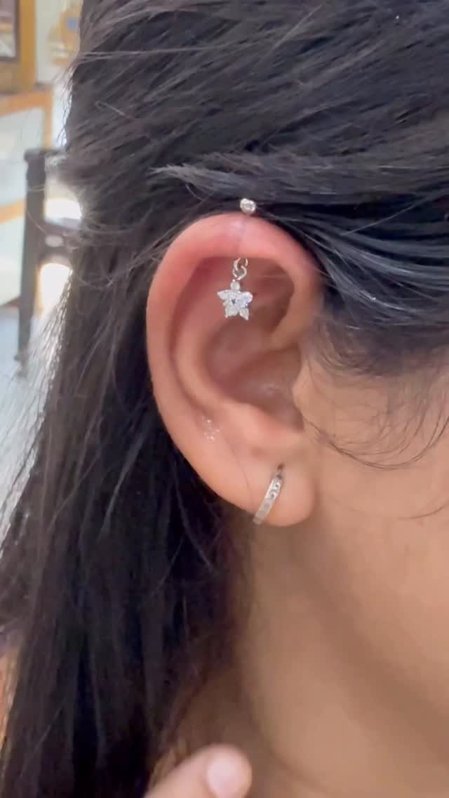 Top of the Ear Piercing Jewelry: 11 Ideas 9 Ear with a silver star charm piercing at the top and a hoop.