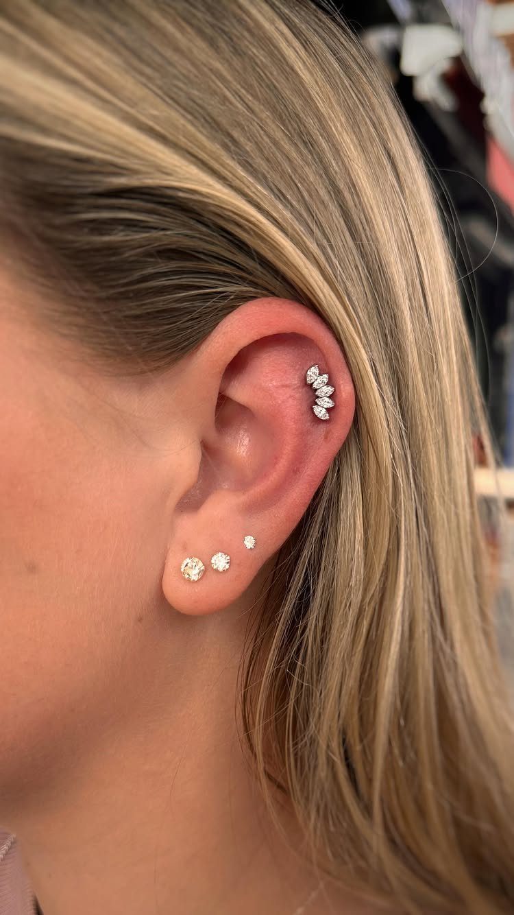 Top of the Ear Piercing Jewelry: 11 Ideas 10 Ear with multiple diamond stud piercings on the lobe and upper cartilage rim.