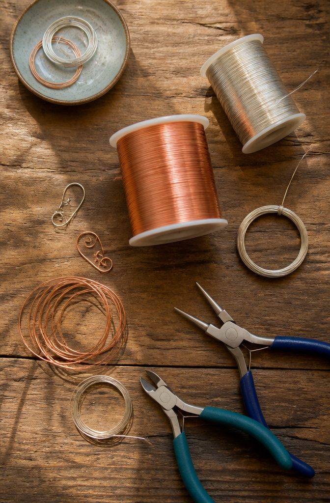 How to Make Wire Jewelry: 6 Steps for Wrapping and Setting Stones 1 Various types of wire including copper and sterling silver for jewelry making.