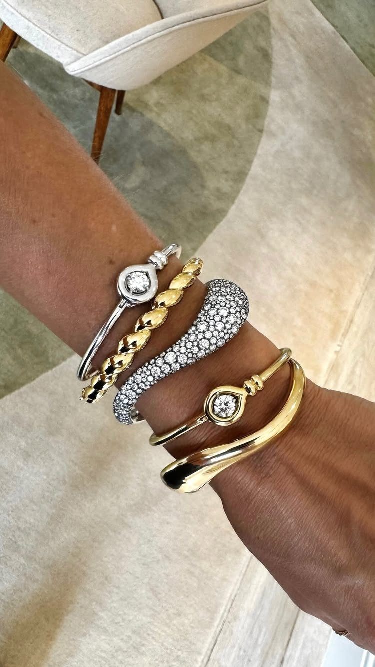 XOXO Jewelry Ideas: 10 Ways to Wear These Timeless Symbols 4 Stack of gold and silver bracelets with diamonds on a person's wrist