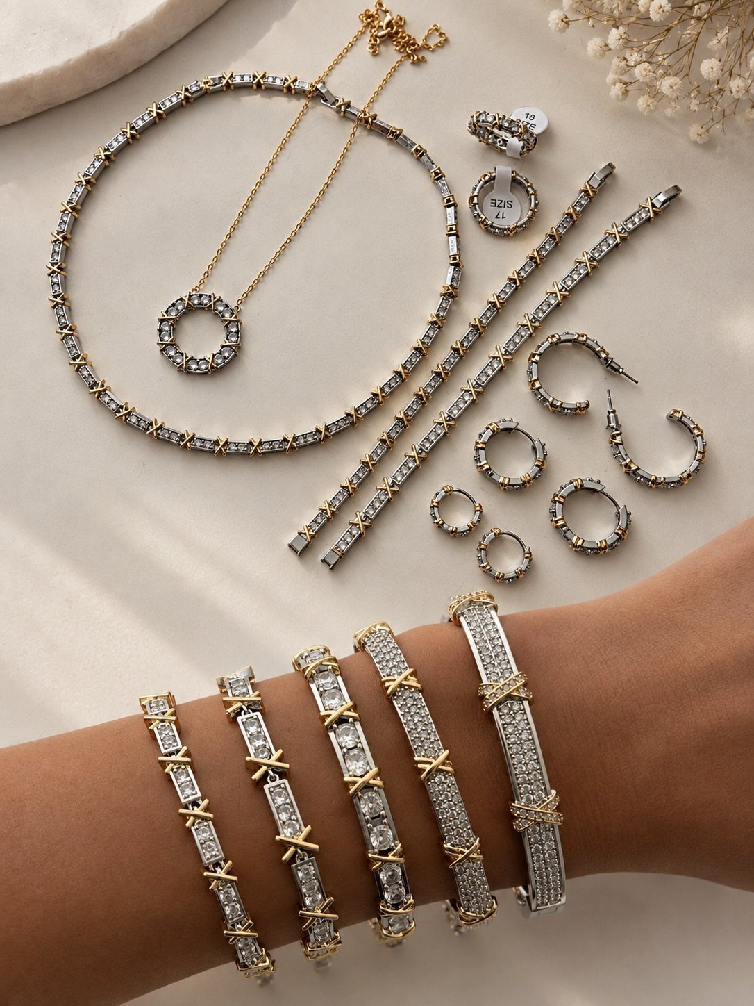 XOXO Jewelry Ideas: 10 Ways to Wear These Timeless Symbols 10 Gold and silver jewelry set with X-shaped crystal patterns on a wrist and table.